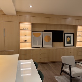 View of kitchen island living room, TV and cabinet wall.